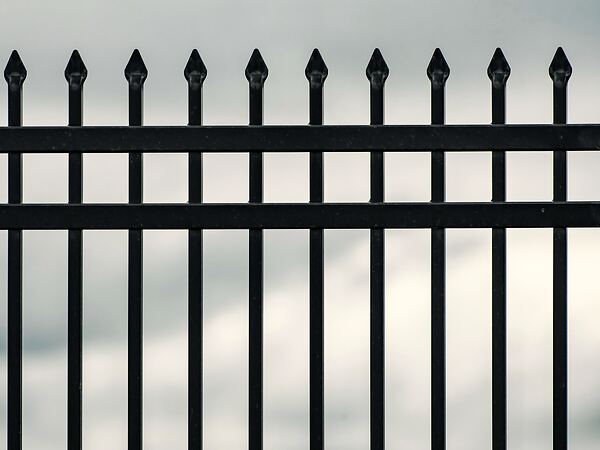 Black metal fence with spear-top pickets