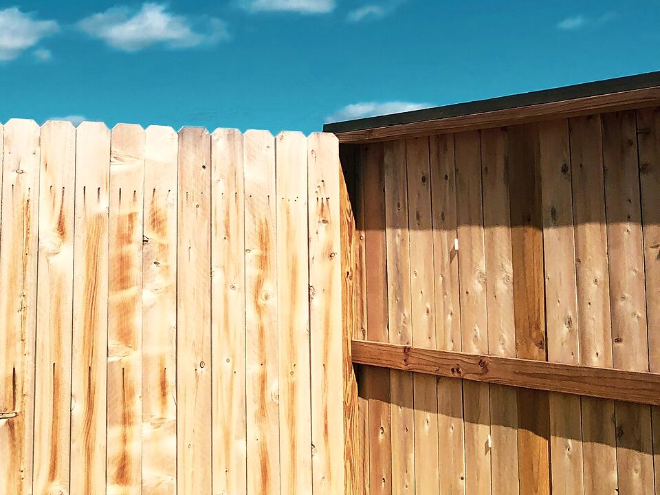 Top of a new dog-ear wood privacy fence
