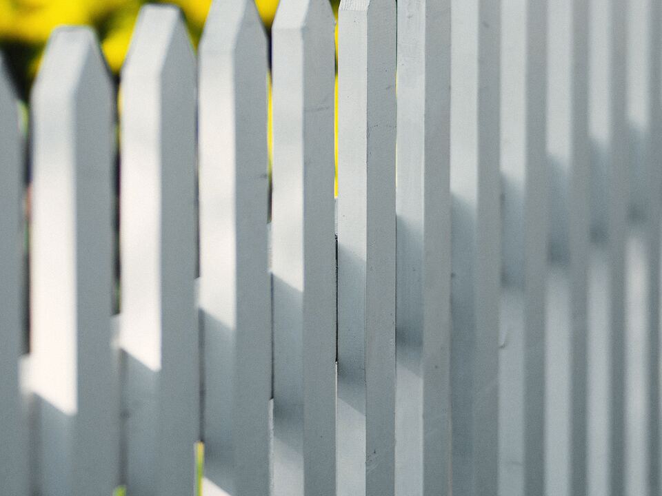 Close-up of white fence pickets
